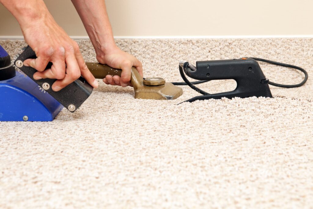 carpet stretcher tool being used to stretch carpet